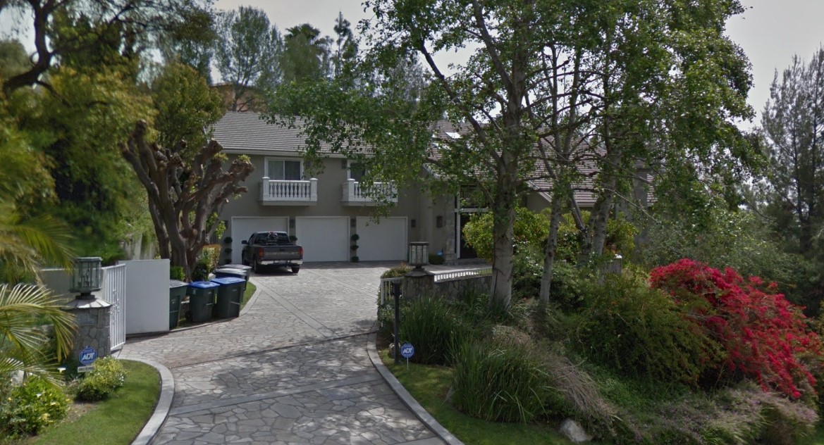 Existing Pasadena residence before demolition — driveway approach with mature trees